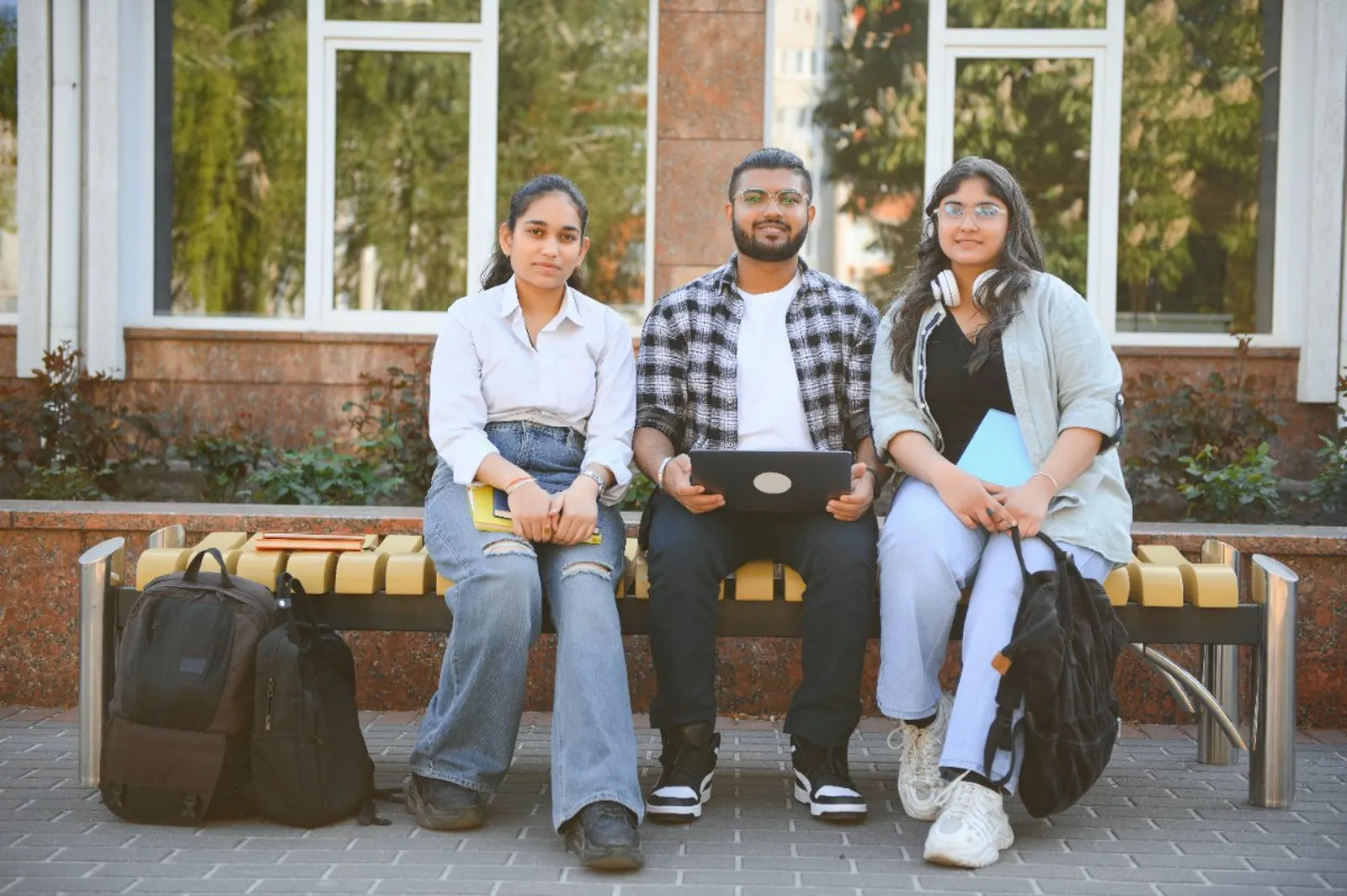 Three passengers waiting for their transportation